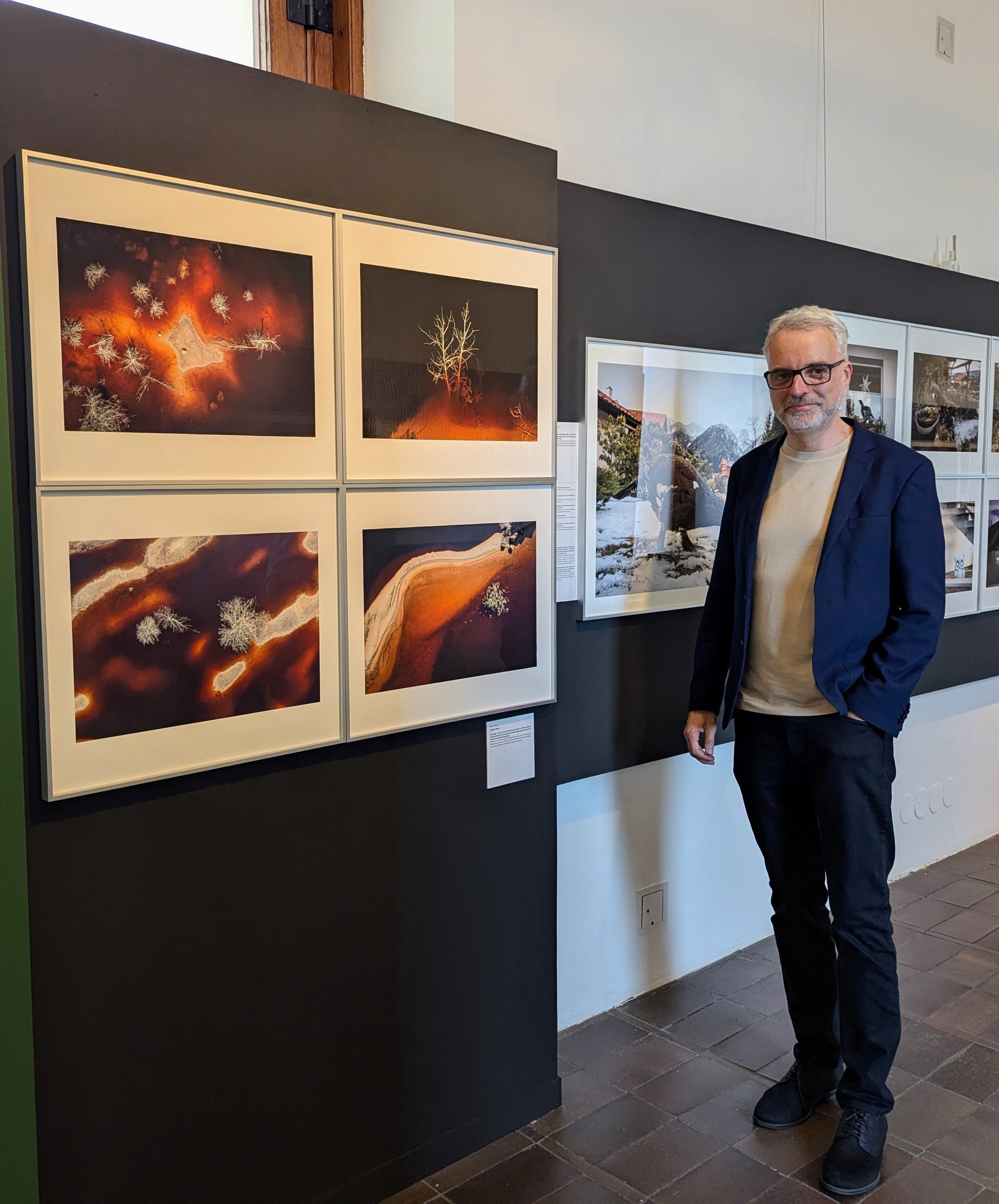 Daniel Franc with his photographs at an exhibition