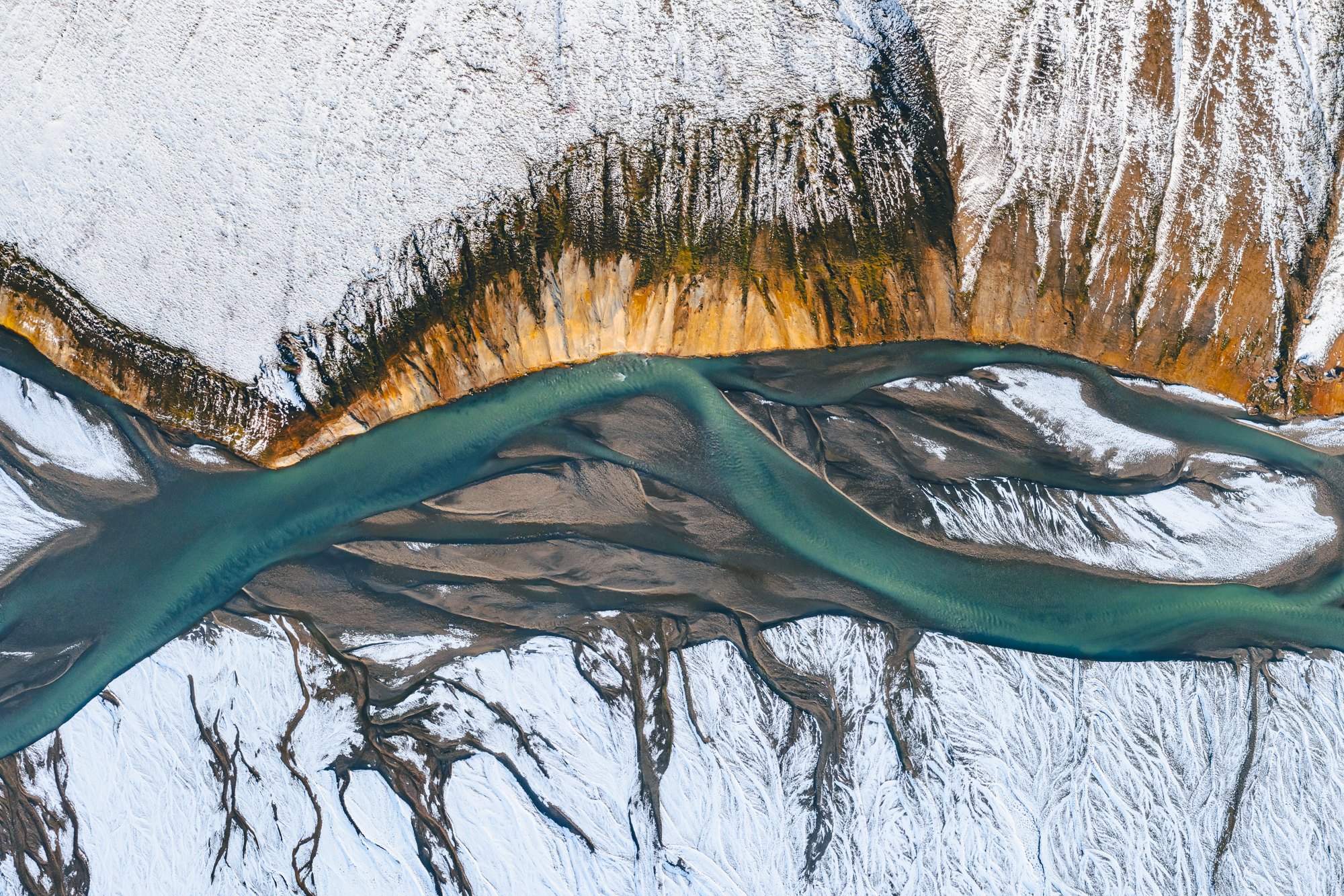 A river in a snowy landscape, drone photograph by Daniel Franc
